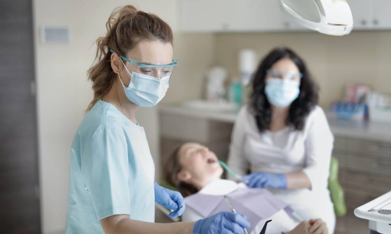 A picture of a female dentist working on a patient. Photo by Andrea Piacquadio from Pexels.