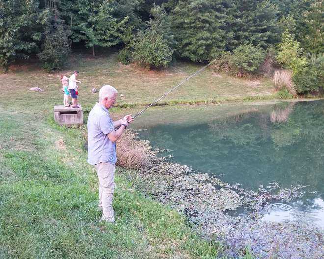 Picture of a man fishing in a small body of water. Picture taken by Adrienne Bunderson.