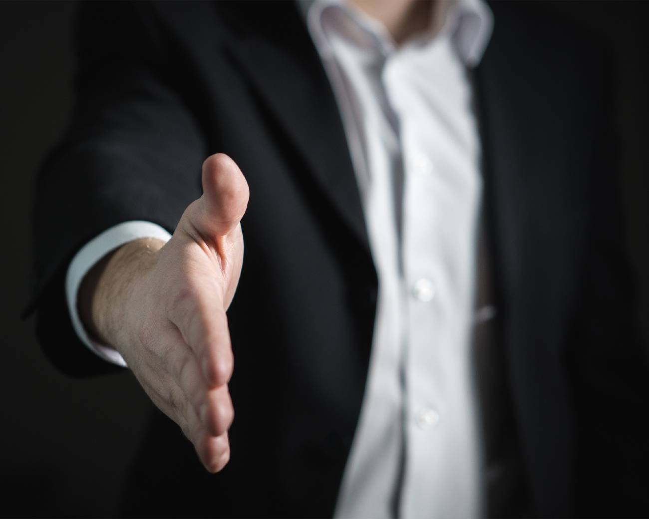 Picture of a hand reaching out to shake the viewers. Photo by Pixabay from Pexels.
