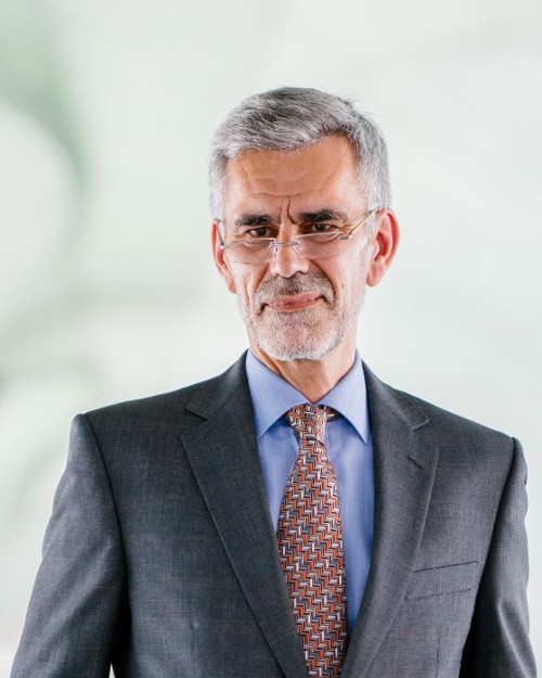 Picture of a man in a grey suit with a colorful tie. Photo by mentatdgt from Pexels.