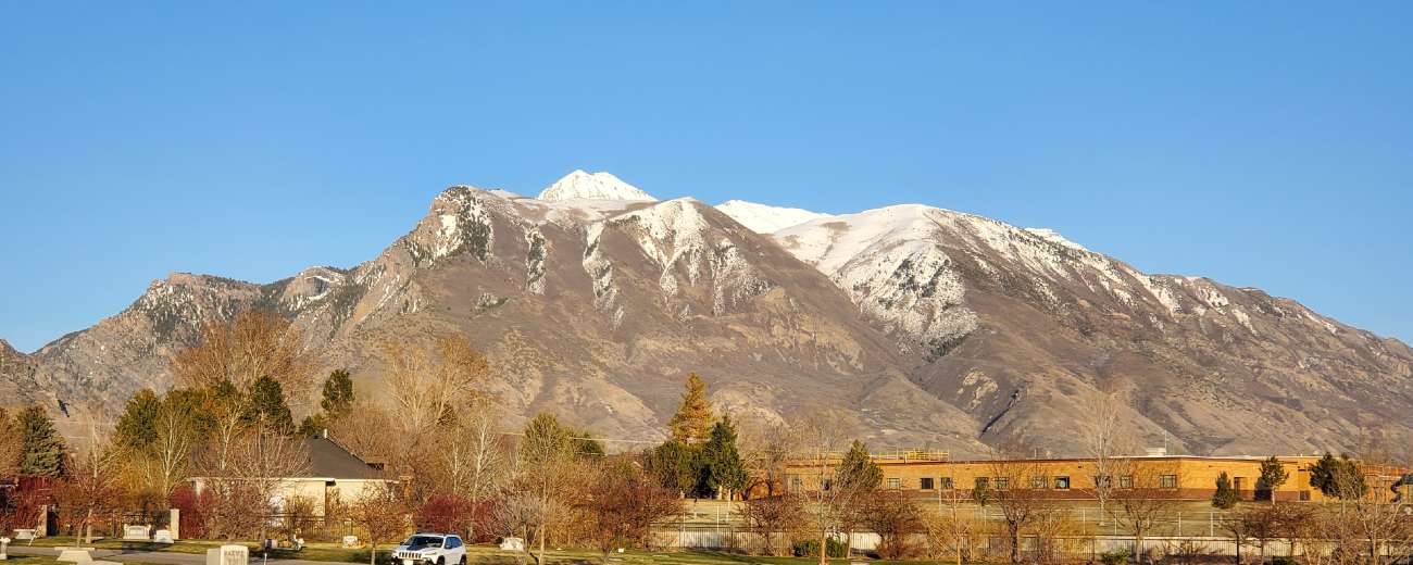 Picture of mountains with a school in the foreground