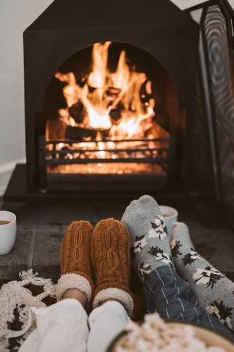 Getting cozy in front of a fire. Photo by Taryn Elliot from Pexels.